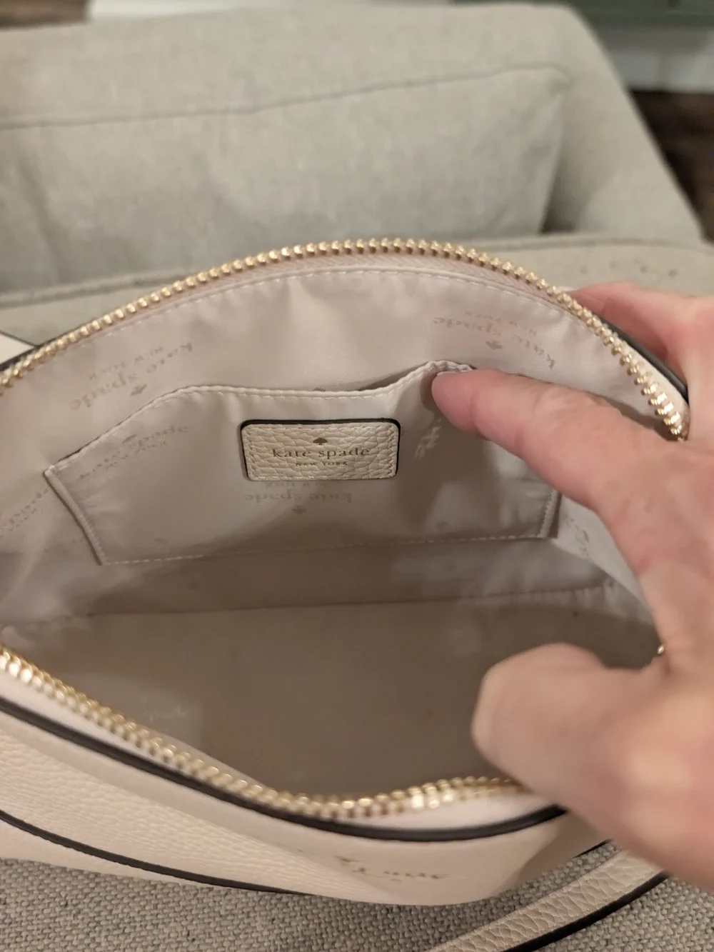 kate spade cream pebbled leather crossbody with gold logo